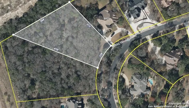 an aerial view of a house with a forest