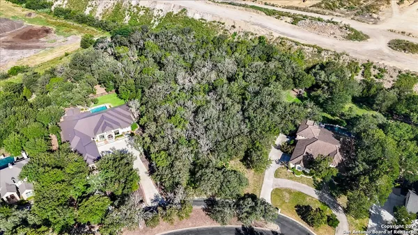 an aerial view of house with yard and mountain view in back