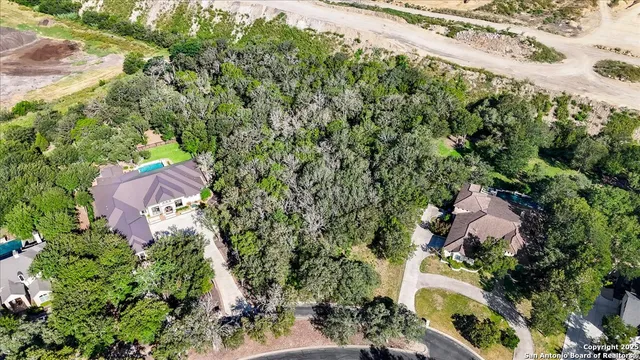 an aerial view of house with yard and mountain view in back