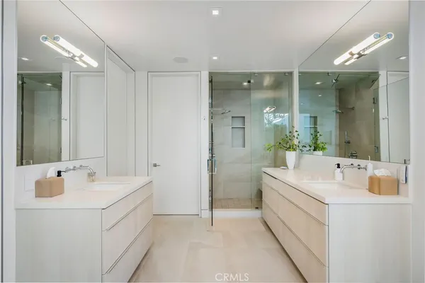 a bathroom with a double vanity sink mirror and