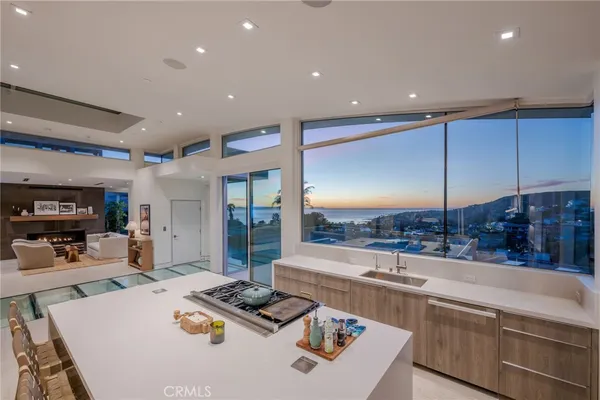 a kitchen with stainless steel appliances kitchen island granite countertop a sink and cabinets