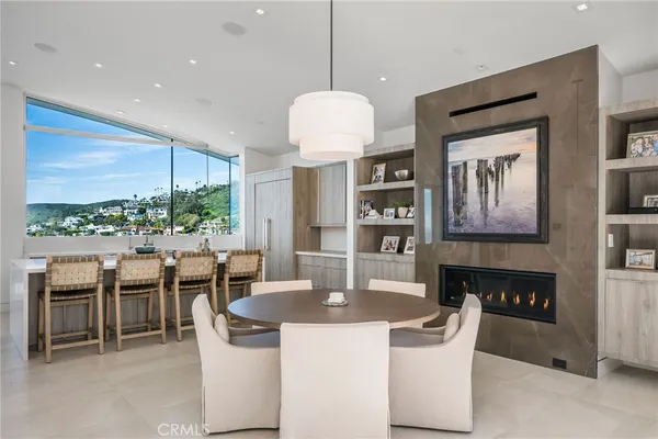 a dining room with furniture and a floor to ceiling window