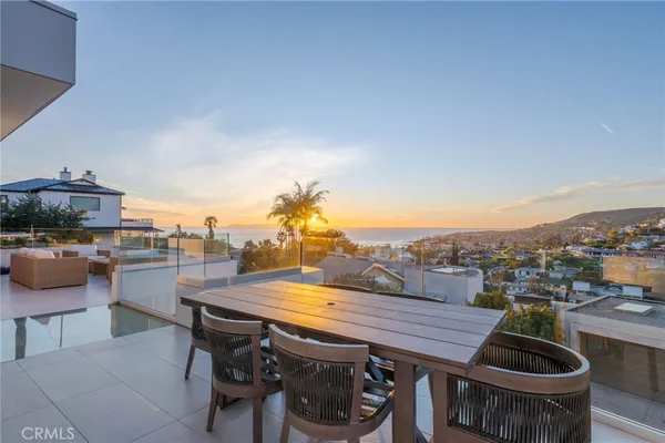 a terrace with outdoor seating and city view