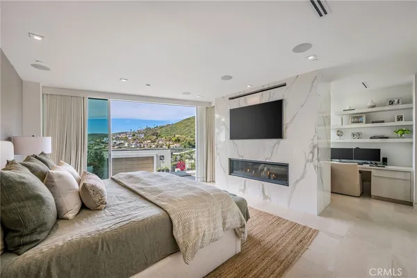a bedroom with a large bed and a flat screen tv