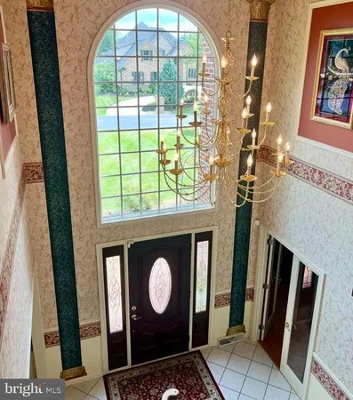 a view of staircase with lots of frames on wall and a potted plant