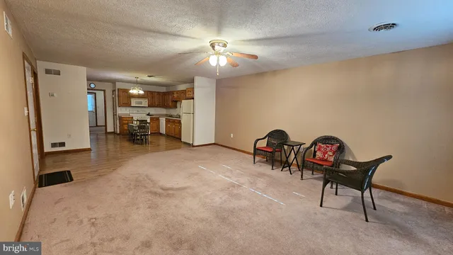 a view of a livingroom with furniture and a ceiling fan