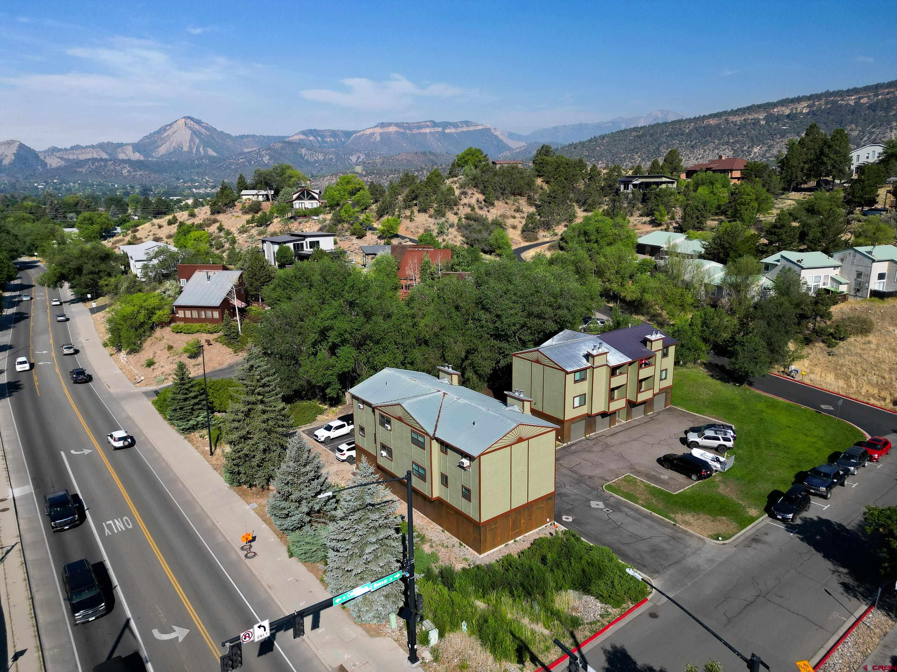 an aerial view of multiple houses with yard