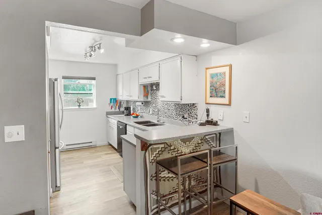 a kitchen with a stove a sink and a refrigerator