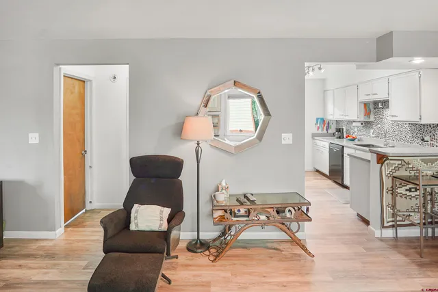 a living room with furniture and a mirror