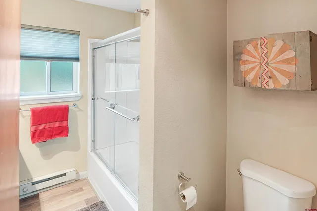 a bathroom with a toilet and a shower curtain