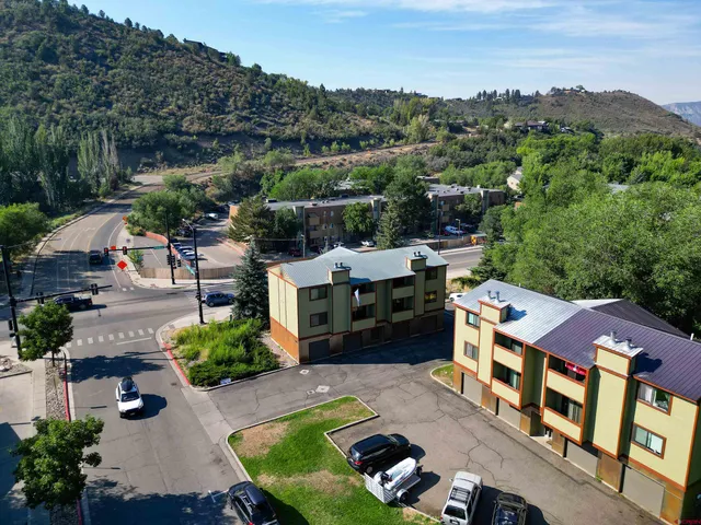 a aerial view of a house with swimming pool and a yard
