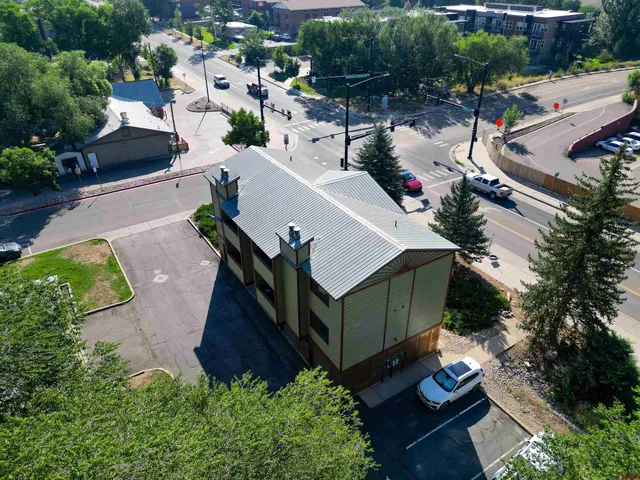 an aerial view of a house with a yard