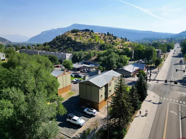 an aerial view of a house with a yard