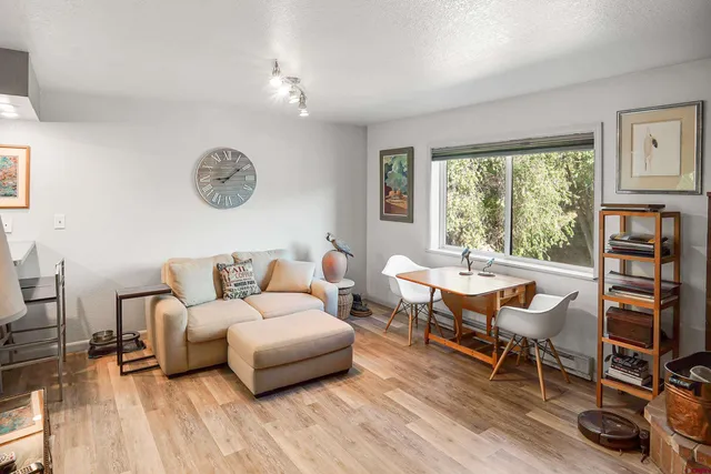a living room with furniture a window and a flat screen tv