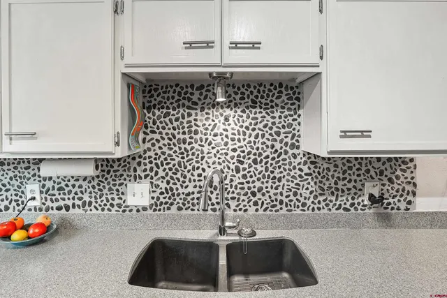 a bathroom with a sink a mirror and shower