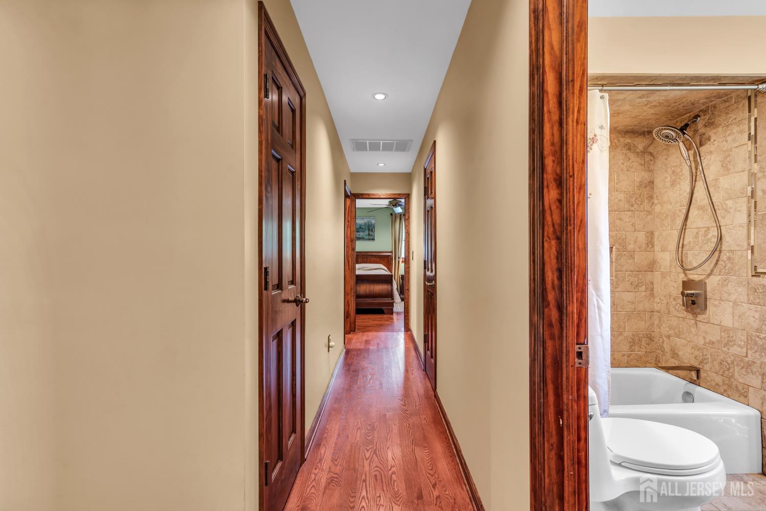 99 Schulmeister Road Old Bridge, NJ 08857 - Photo 13 of 49 a view of a hallway with wooden floor and a bathroom