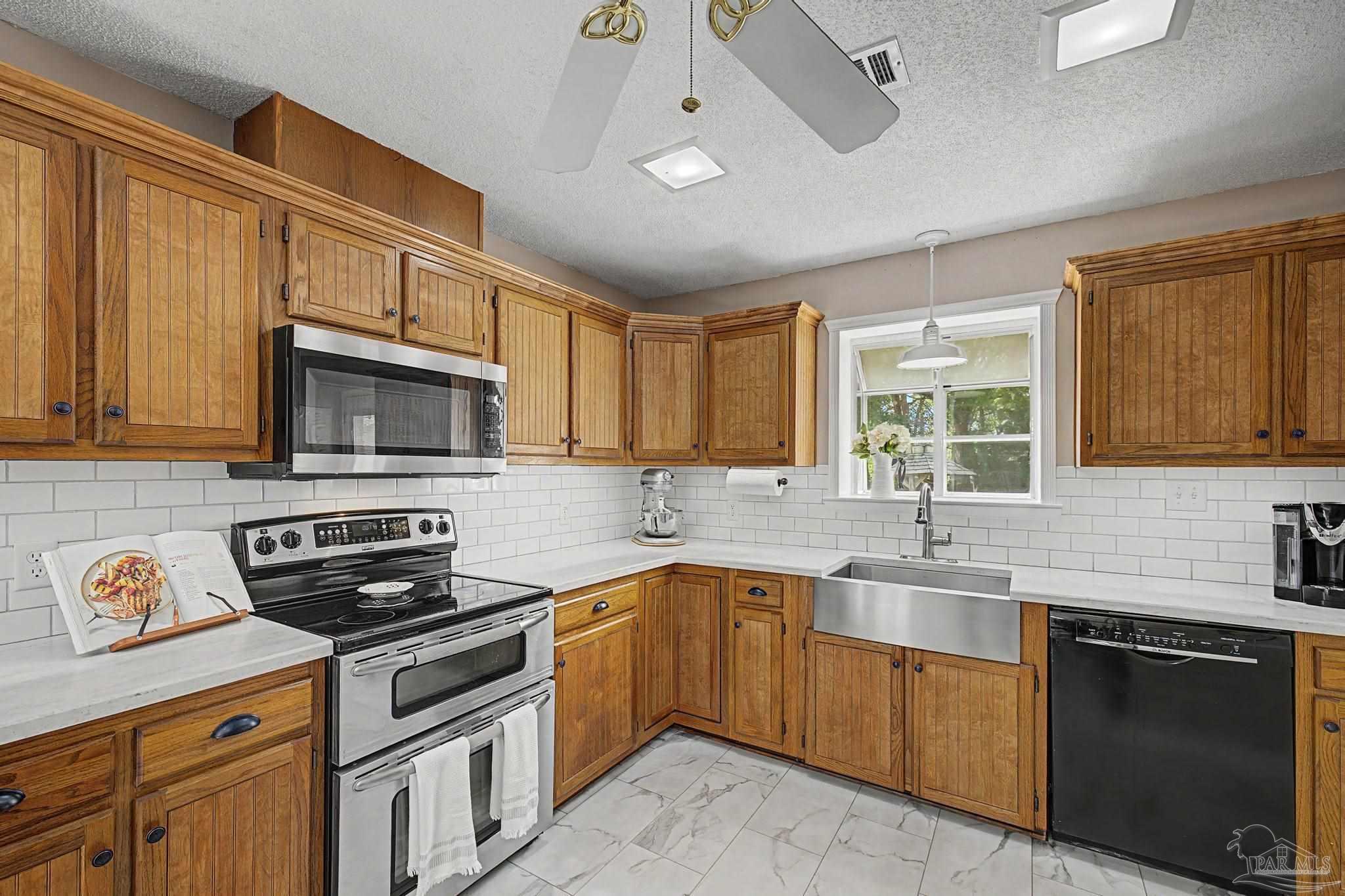 4959 Skipper Lane Pace, FL 32571 - Photo 11 of 51 a kitchen with a sink stove and microwave