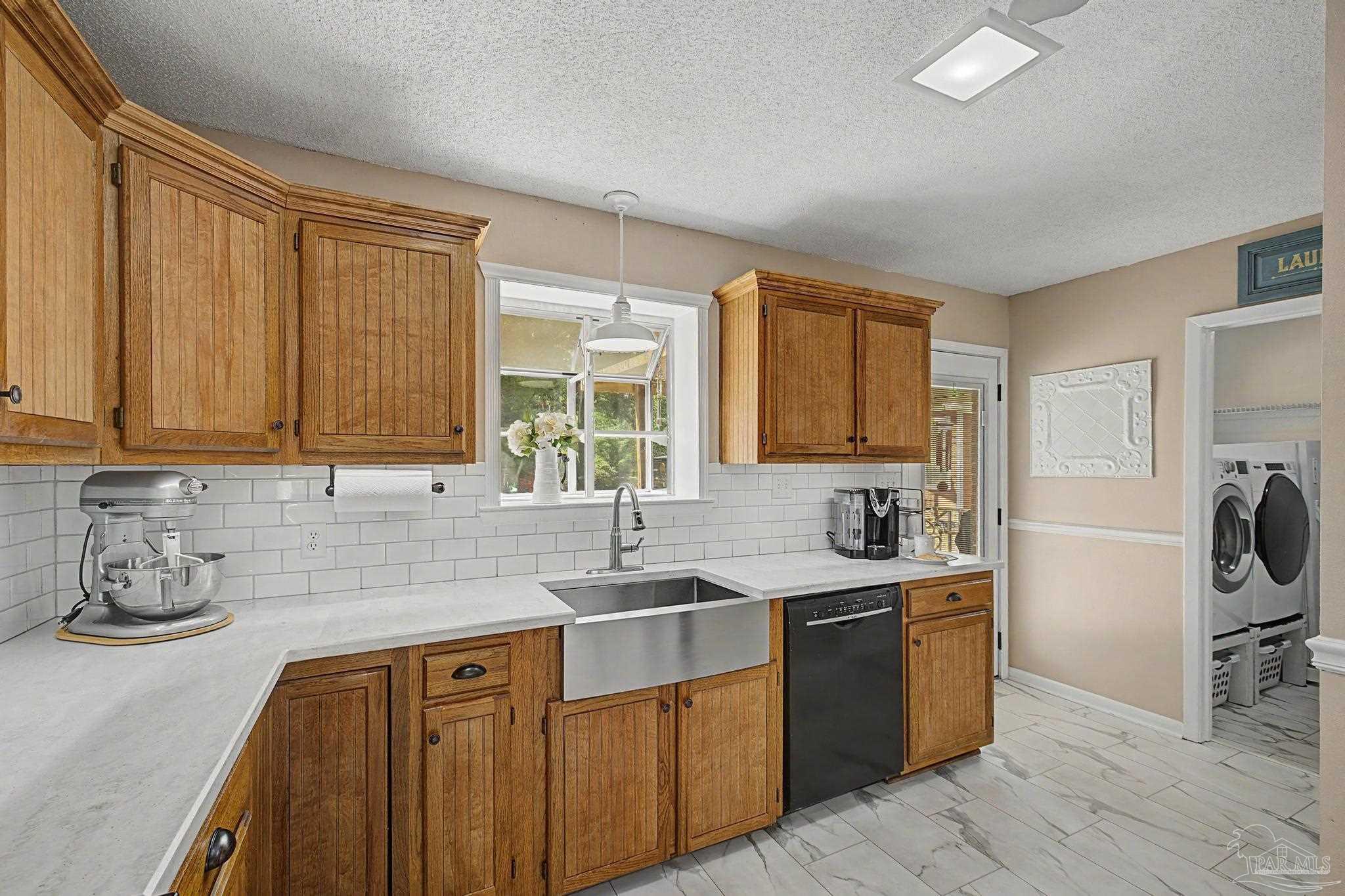 4959 Skipper Lane Pace, FL 32571 - Photo 12 of 51 a kitchen with stainless steel appliances granite countertop a sink stove and refrigerator