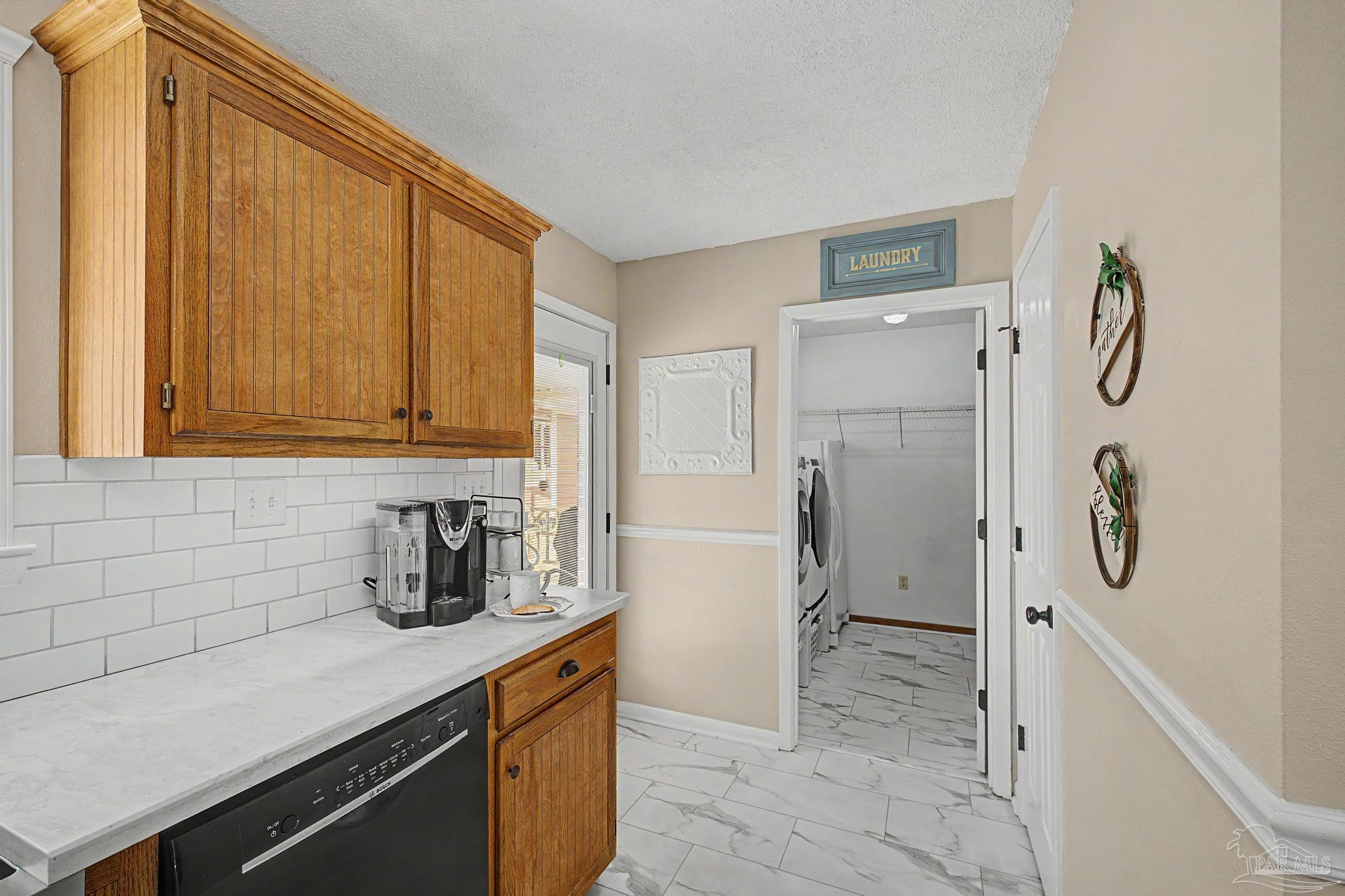 4959 Skipper Lane Pace, FL 32571 - Photo 13 of 51 a kitchen with a refrigerator and a sink