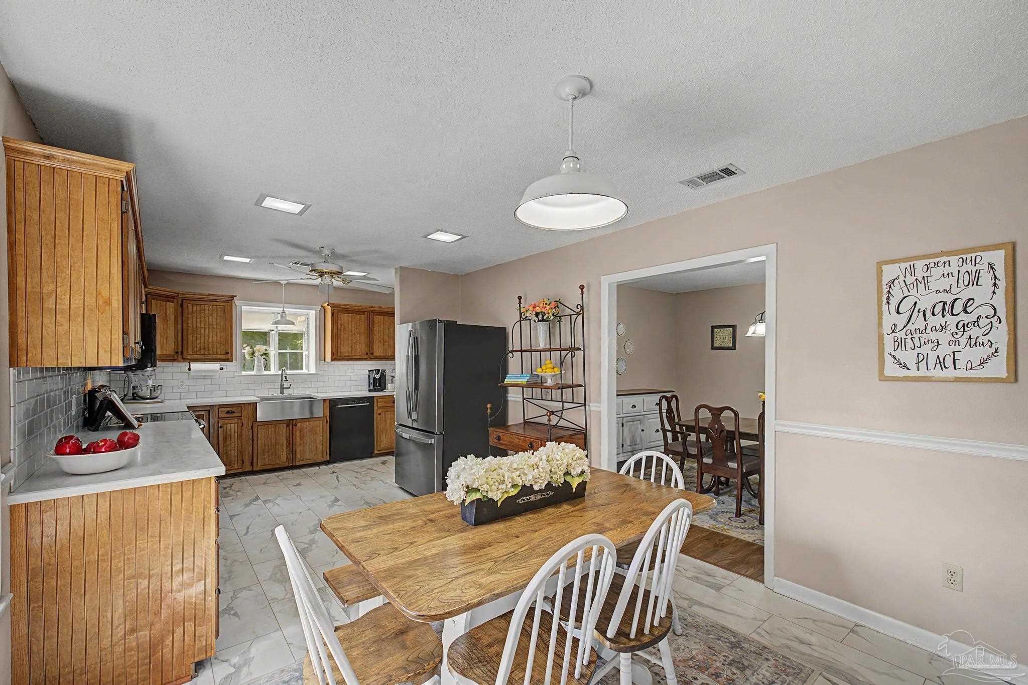 4959 Skipper Lane Pace, FL 32571 - Photo 15 of 51 a view of a dining room with furniture