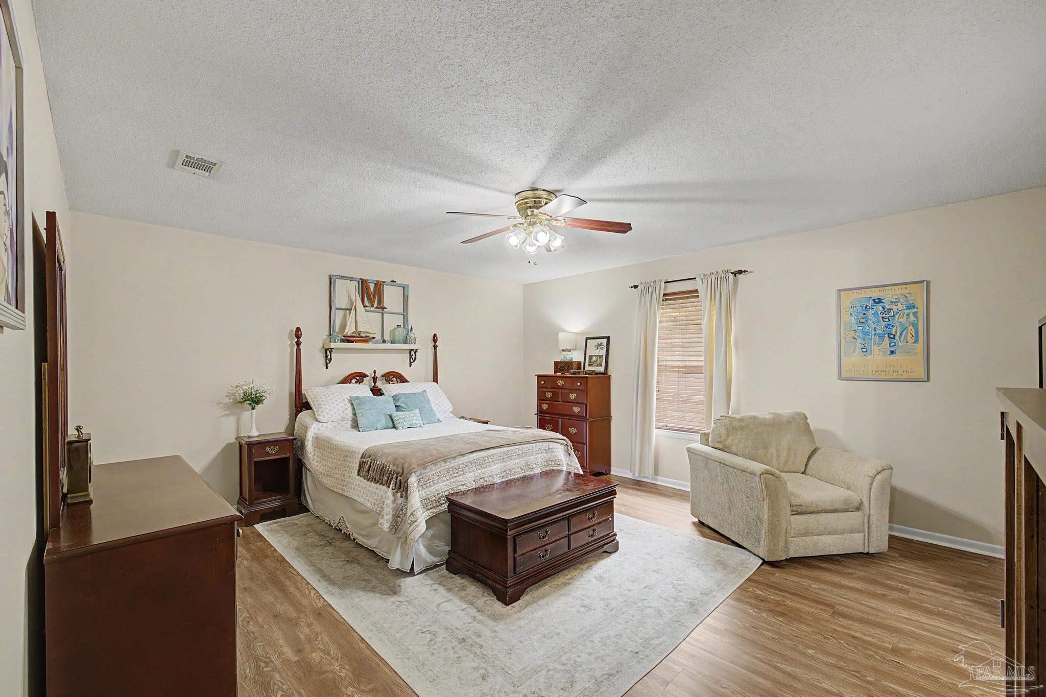 4959 Skipper Lane Pace, FL 32571 - Photo 18 of 51 a bedroom with a bed couch and a window