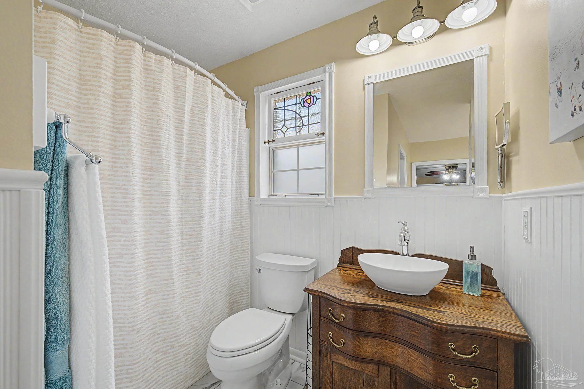 4959 Skipper Lane Pace, FL 32571 - Photo 22 of 51 a bathroom with a toilet a sink and mirror