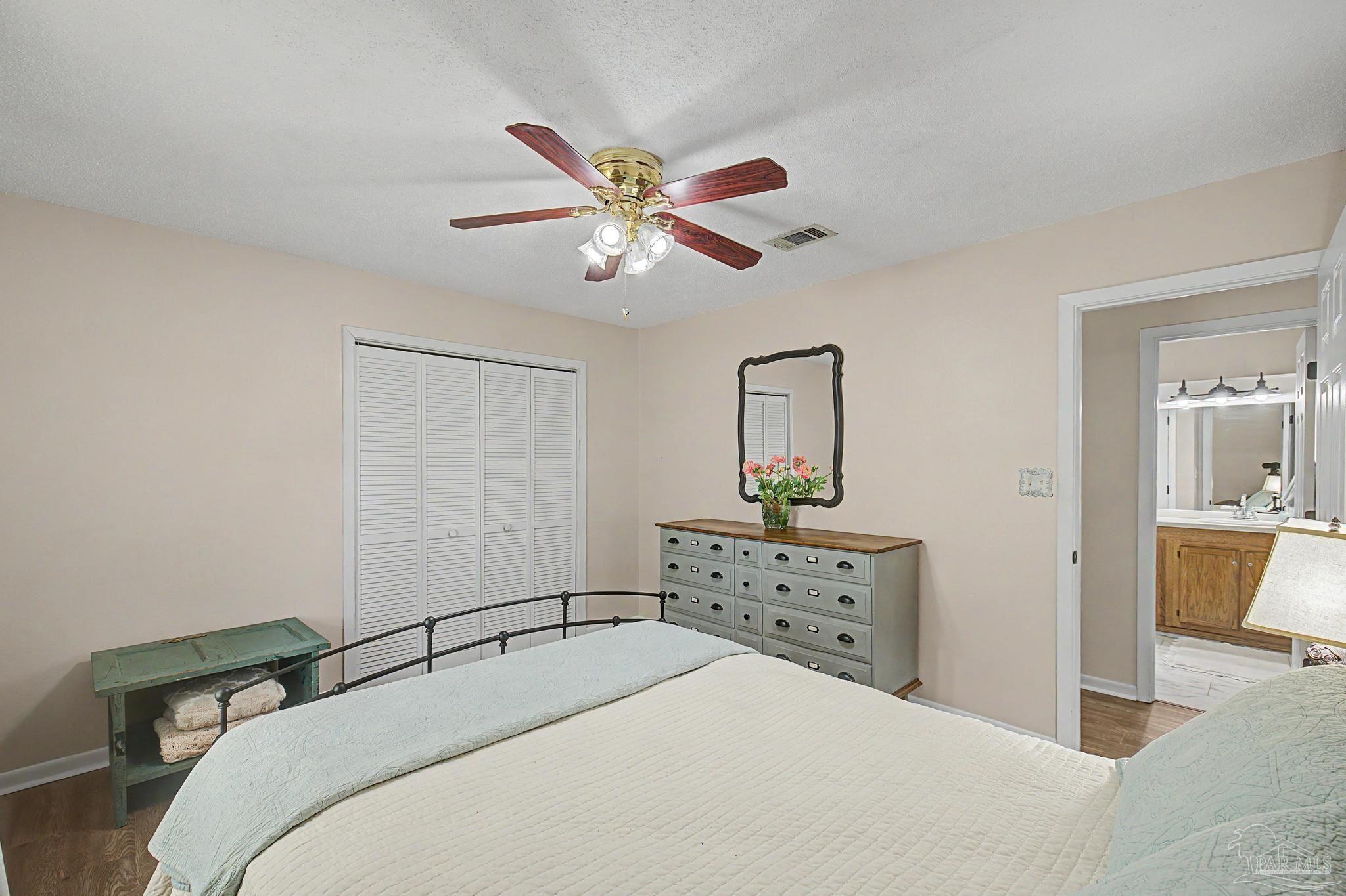 4959 Skipper Lane Pace, FL 32571 - Photo 25 of 51 a bedroom with a bed and a chandelier