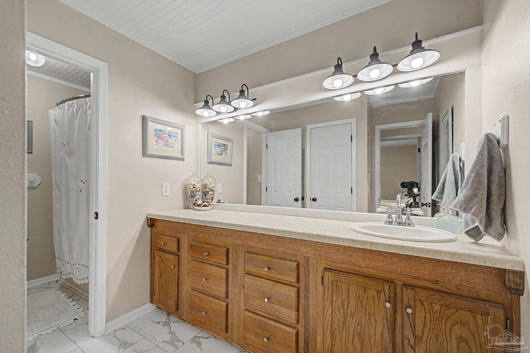 4959 Skipper Lane Pace, FL 32571 - Photo 28 of 51 a bathroom with a double vanity sink and a mirror