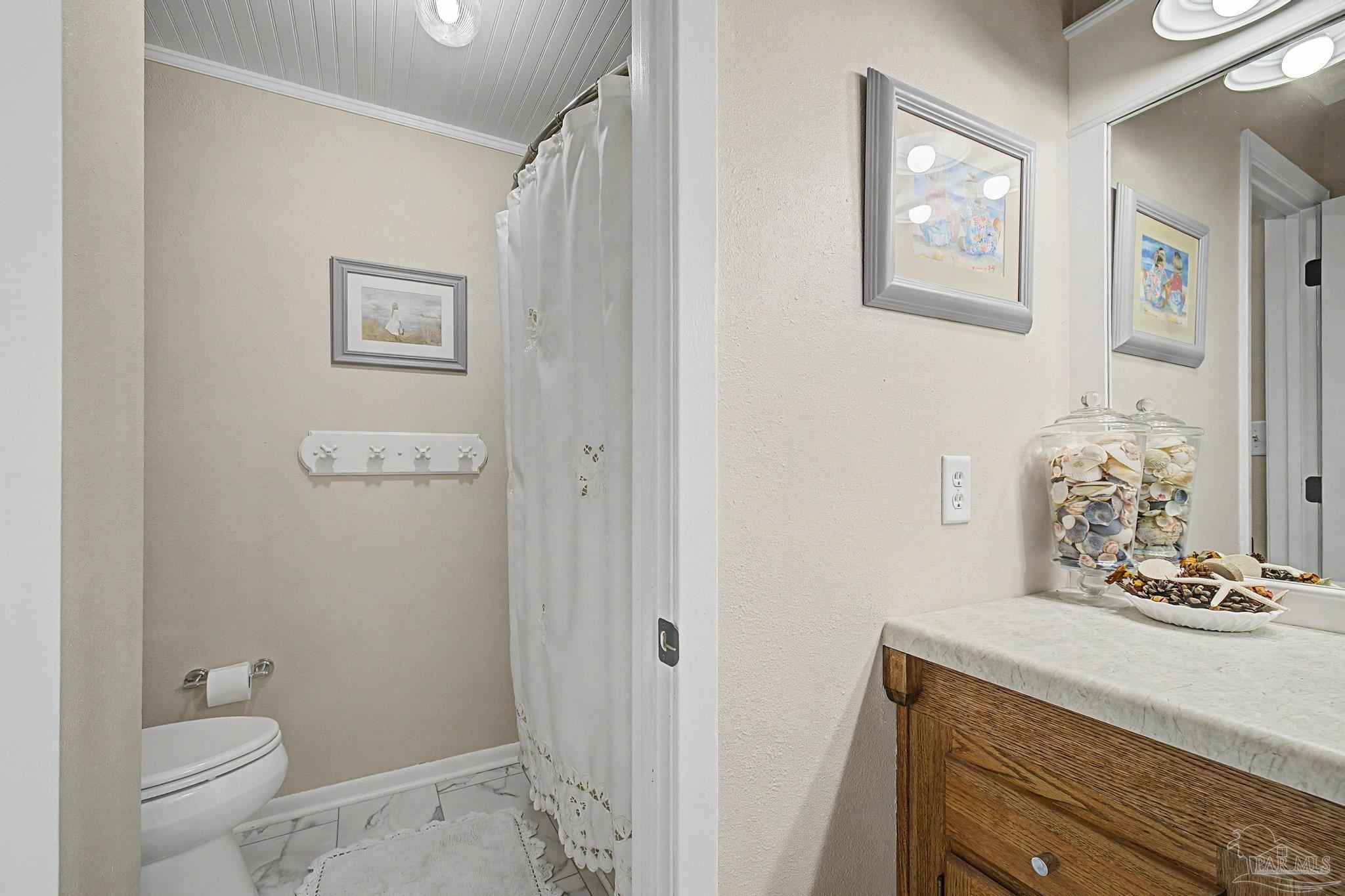 4959 Skipper Lane Pace, FL 32571 - Photo 29 of 51 a bathroom with a granite countertop sink mirror vanity and toilet