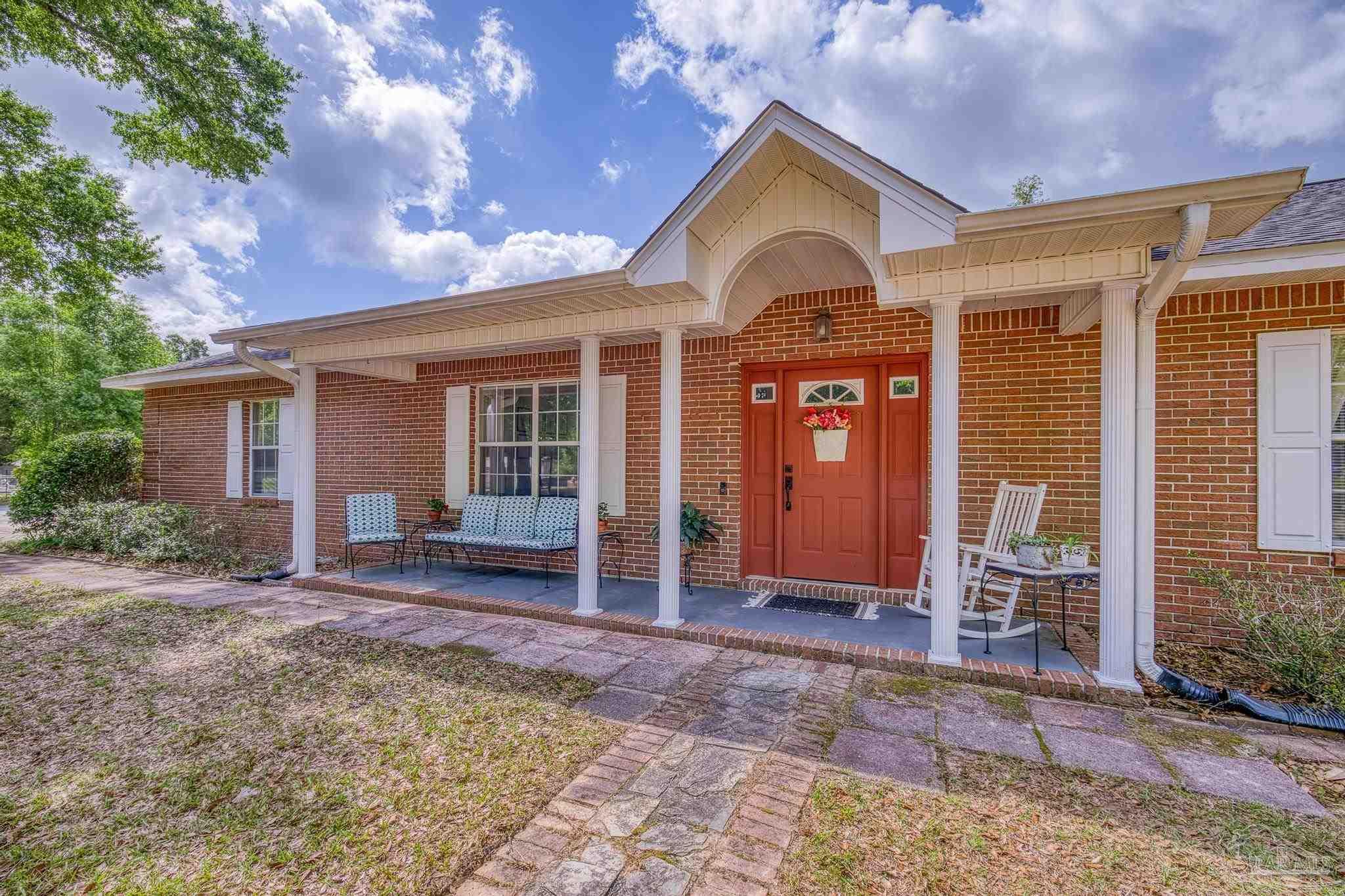 4959 Skipper Lane Pace, FL 32571 - Photo 3 of 51 a front view of a house with garden