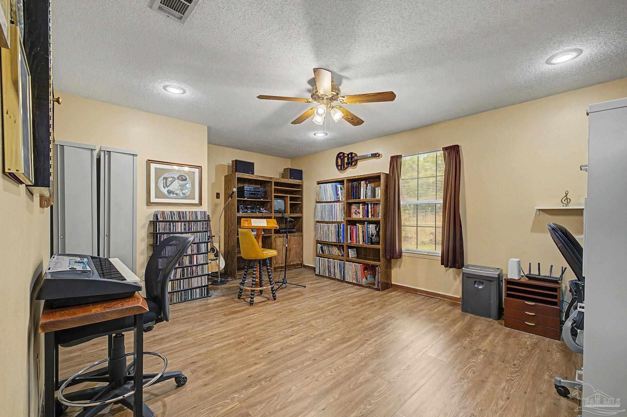 4959 Skipper Lane Pace, FL 32571 - Photo 32 of 51 a view of a livingroom with furniture and a ceiling fan
