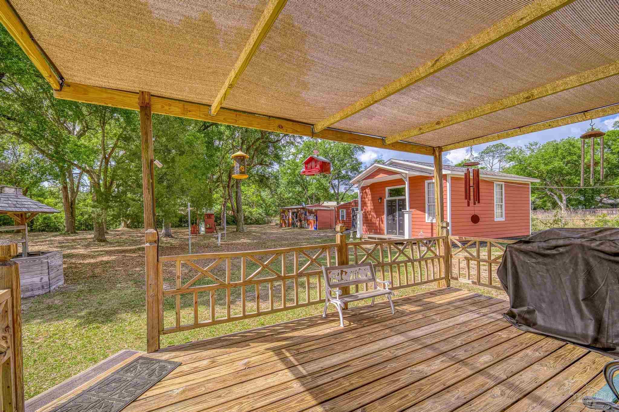 4959 Skipper Lane Pace, FL 32571 - Photo 37 of 51 a view of a house with wooden deck