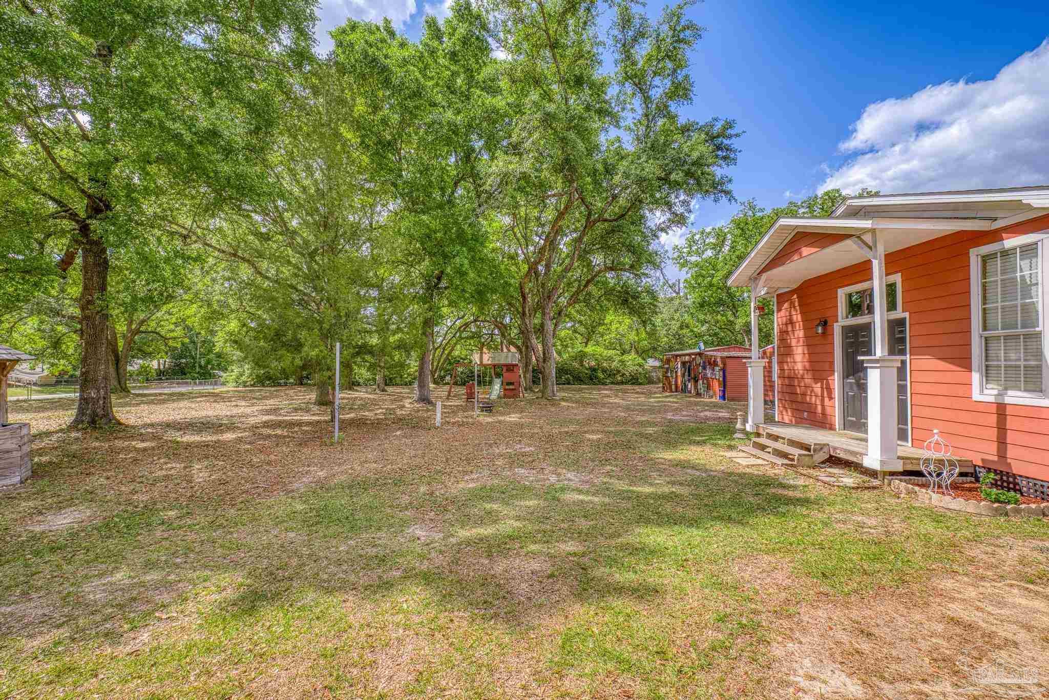 4959 Skipper Lane Pace, FL 32571 - Photo 38 of 51 a view of a house with backyard and tree