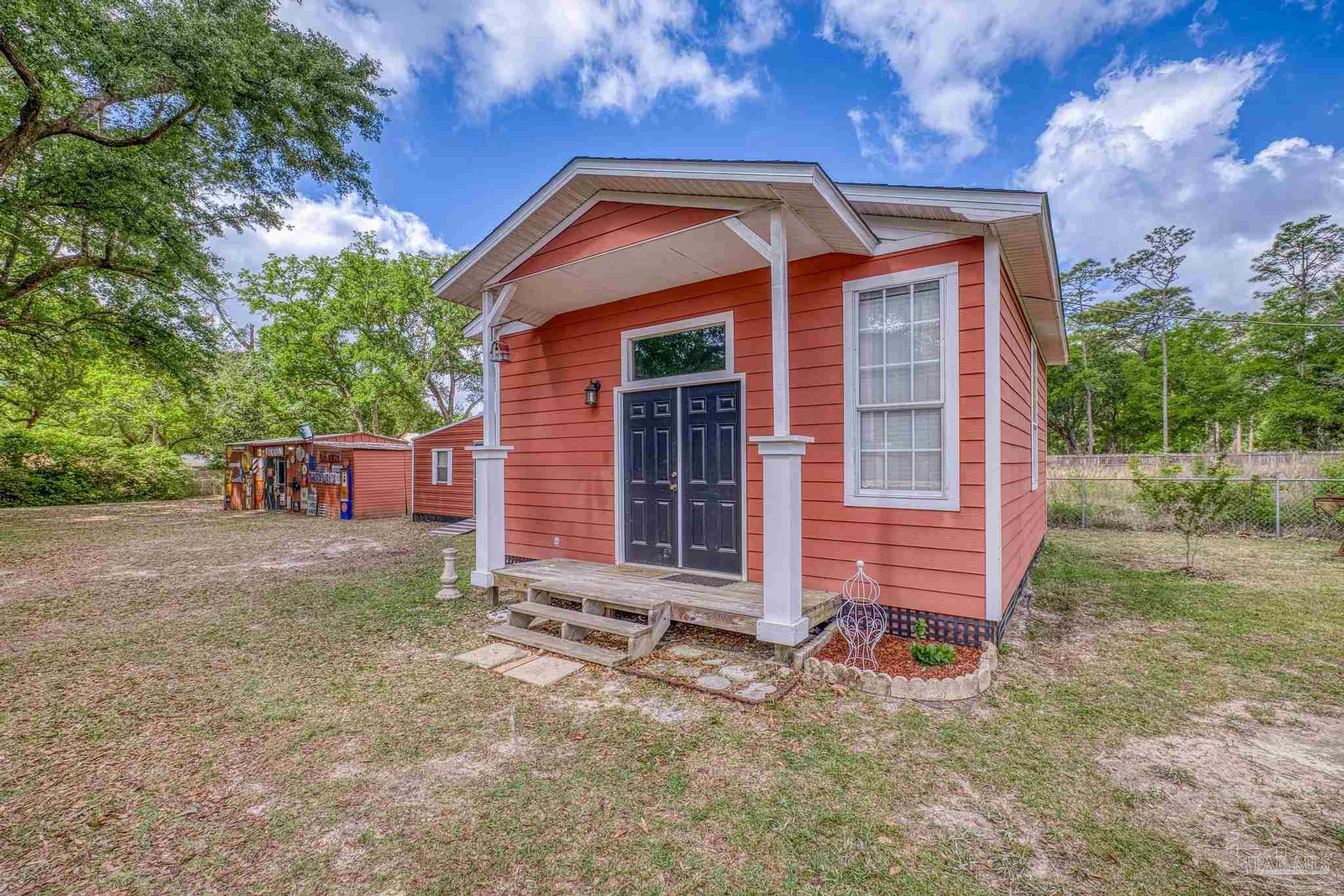 4959 Skipper Lane Pace, FL 32571 - Photo 39 of 51 a front view of a house with a yard