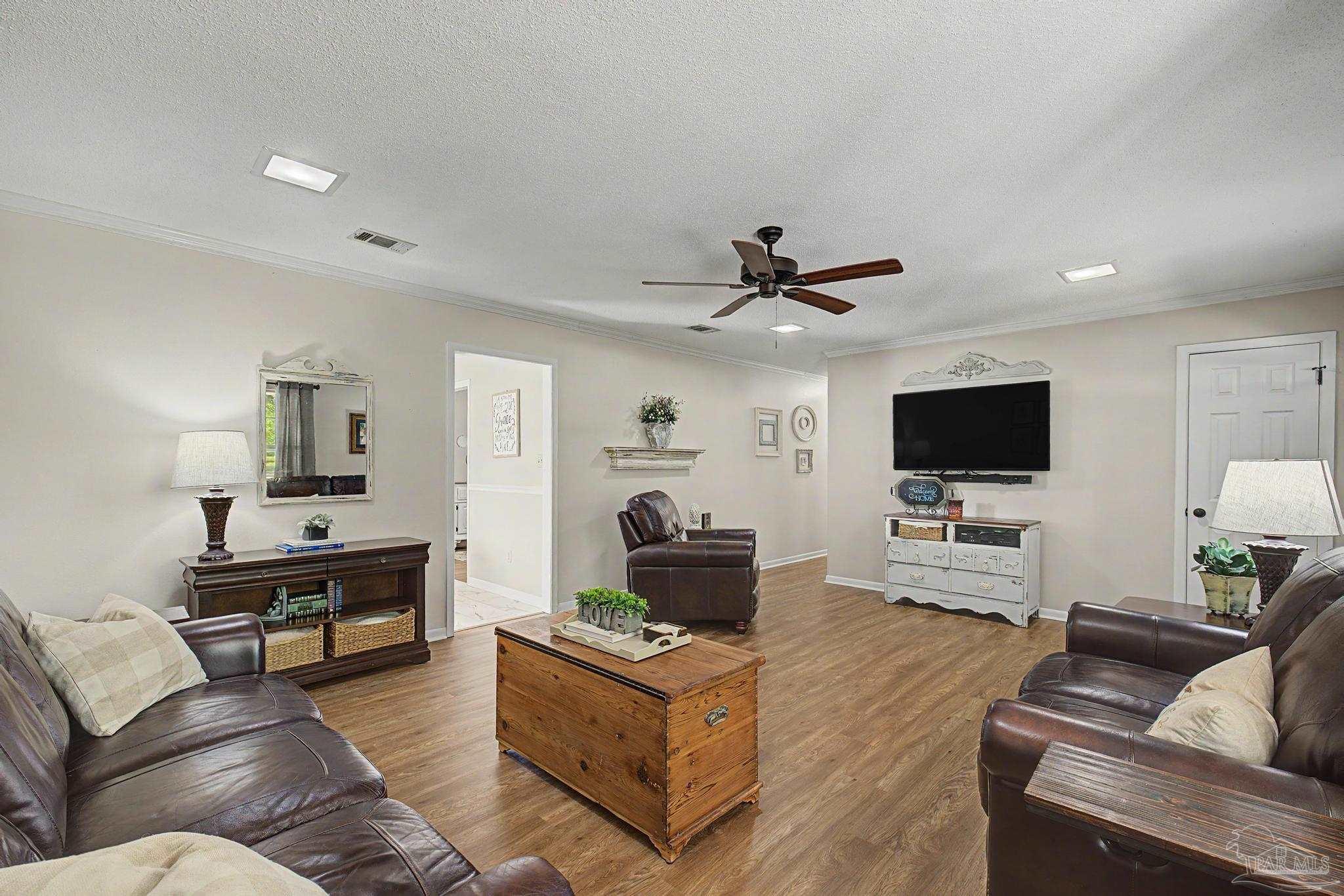 4959 Skipper Lane Pace, FL 32571 - Photo 6 of 51 a living room with furniture and a flat screen tv