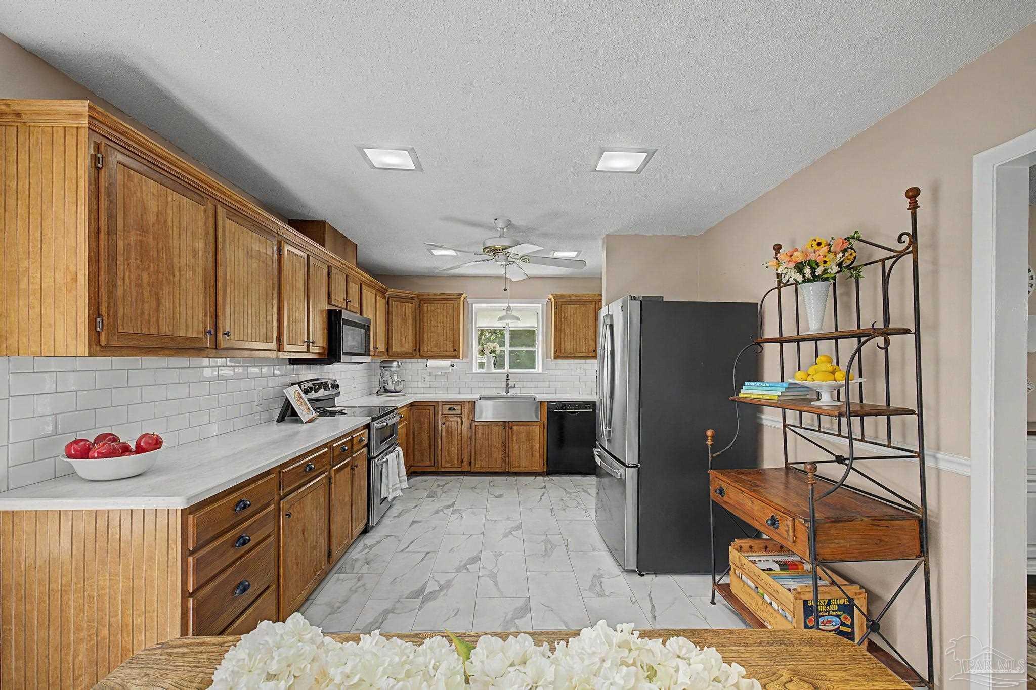 4959 Skipper Lane Pace, FL 32571 - Photo 9 of 51 a kitchen with stainless steel appliances granite countertop a refrigerator and a stove
