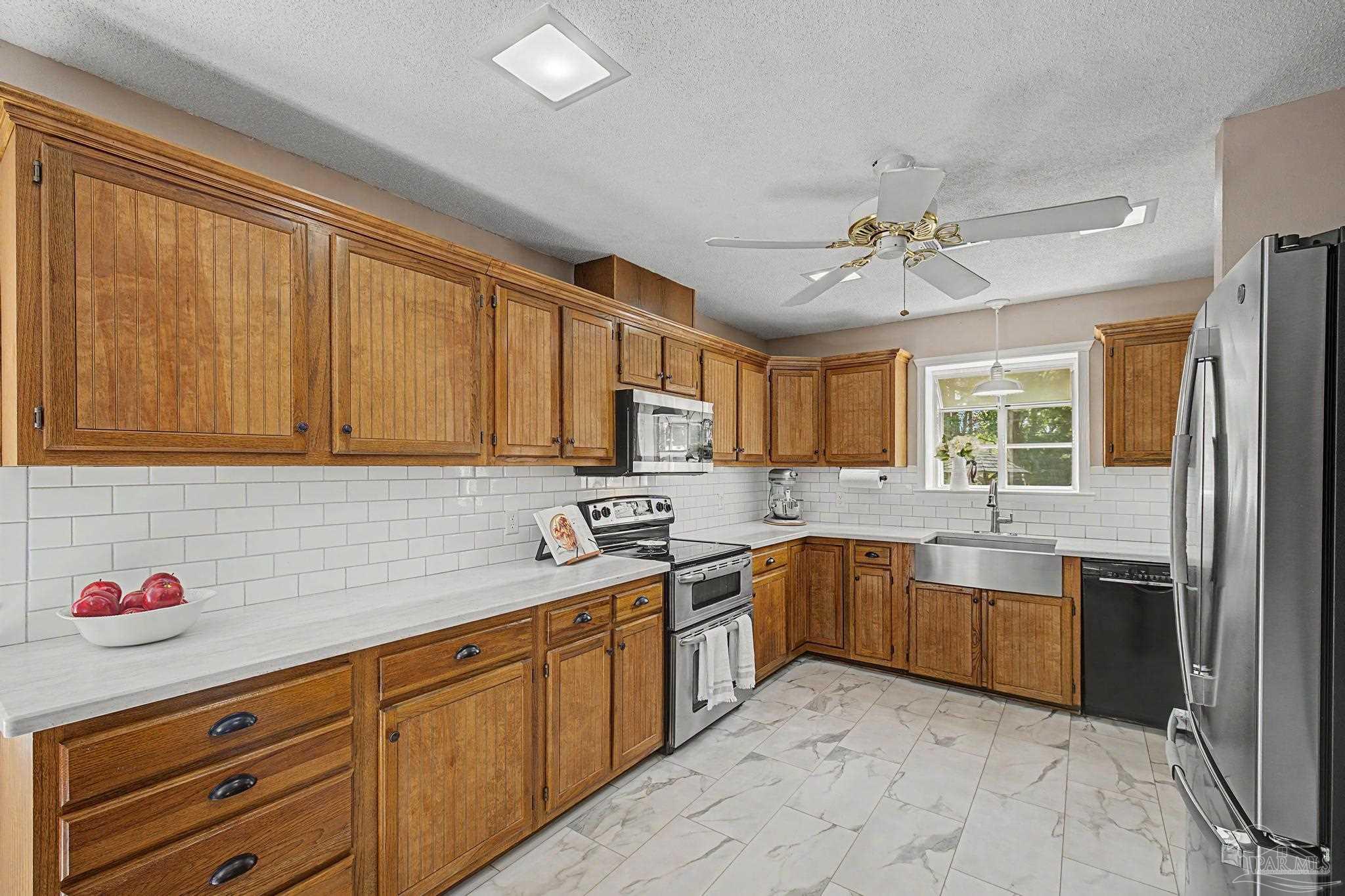4959 Skipper Lane Pace, FL 32571 - Photo 10 of 51 a kitchen with a sink stove and cabinets