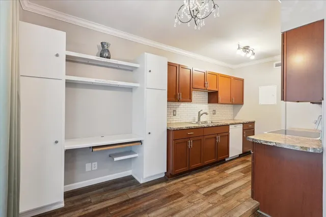 a kitchen with granite countertop a refrigerator and a sink