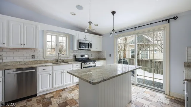 a kitchen with sink stove and cabinets