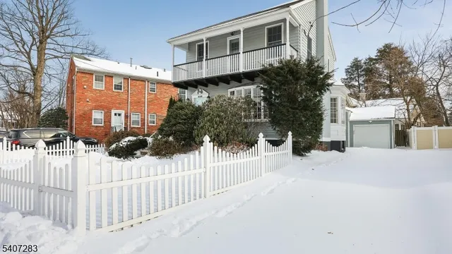 a view of a house with a wooden fence