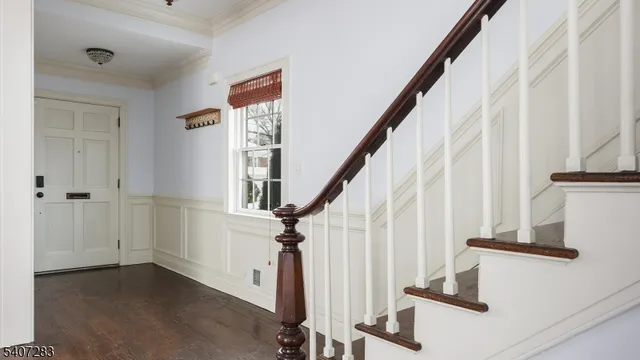 a view of entryway with wooden floor and stairs