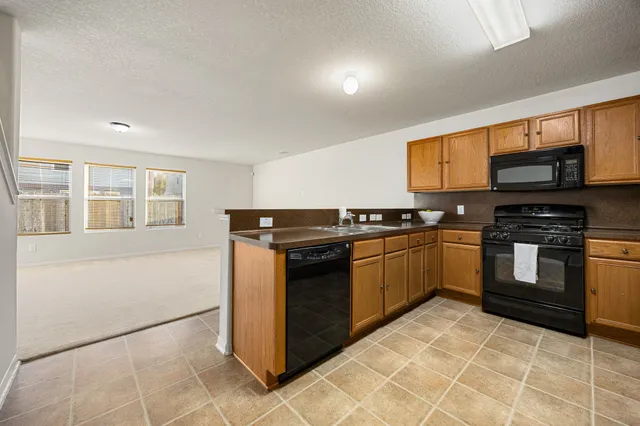 a kitchen with granite countertop a sink and cabinets