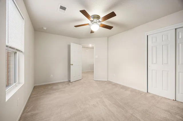 a spacious bathroom with a double vanity sink toilet and a mirror