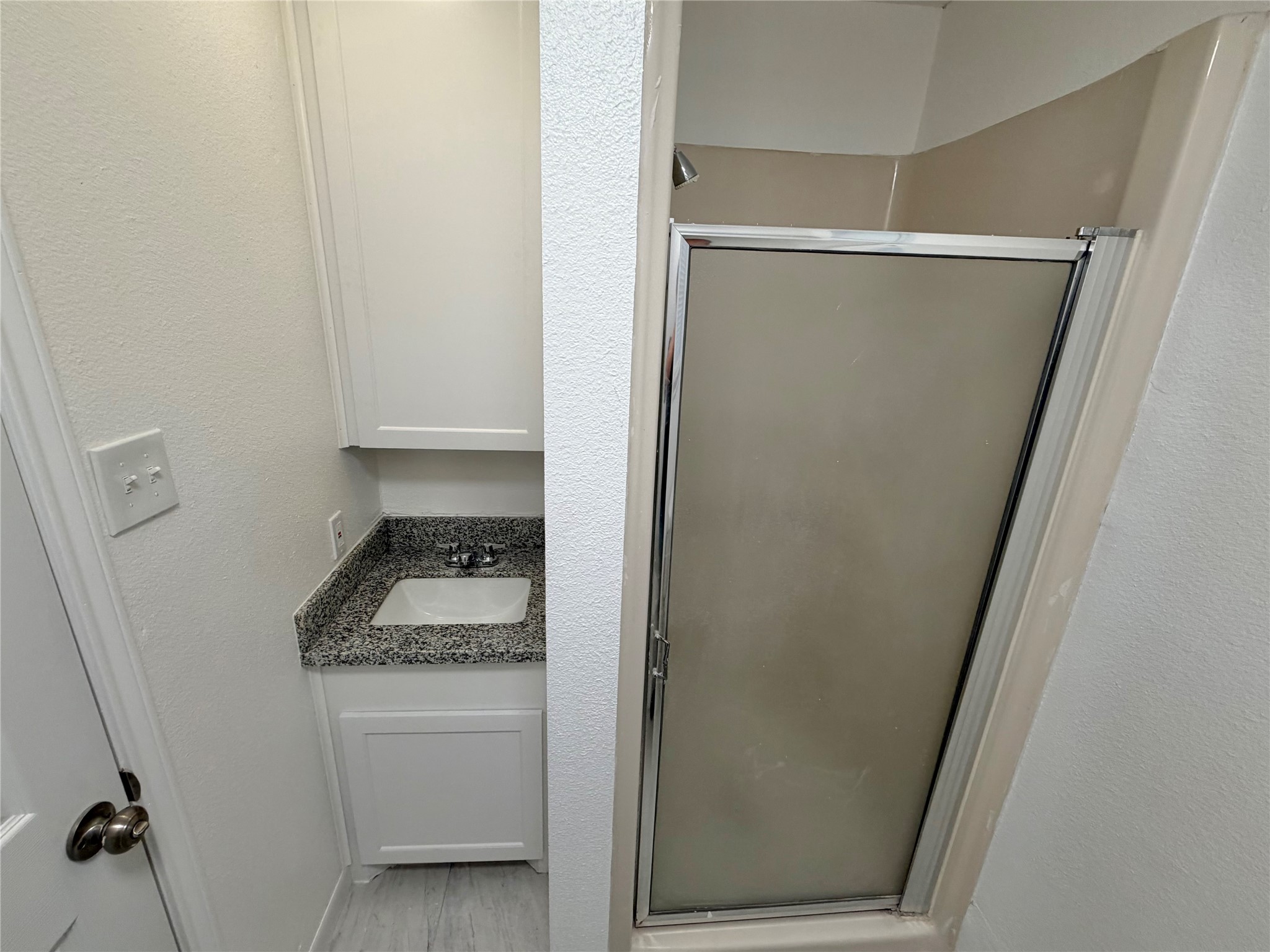 316 Angle Street Angleton, TX 77515 - Photo 19 of 30 a bathroom with a granite countertop sink toilet and shower