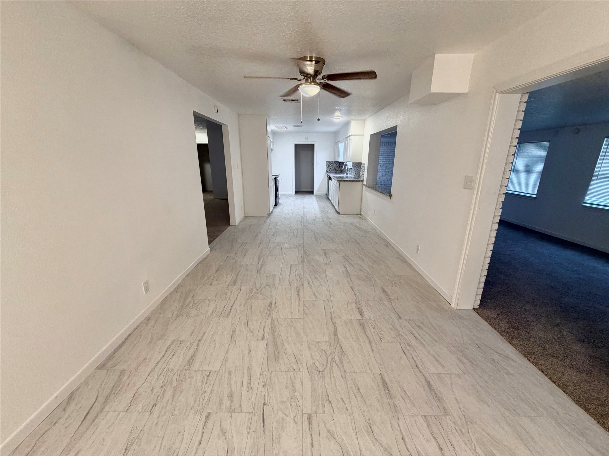 316 Angle Street Angleton, TX 77515 - Photo 20 of 30 a view of a livingroom with wooden floor and a ceiling fan