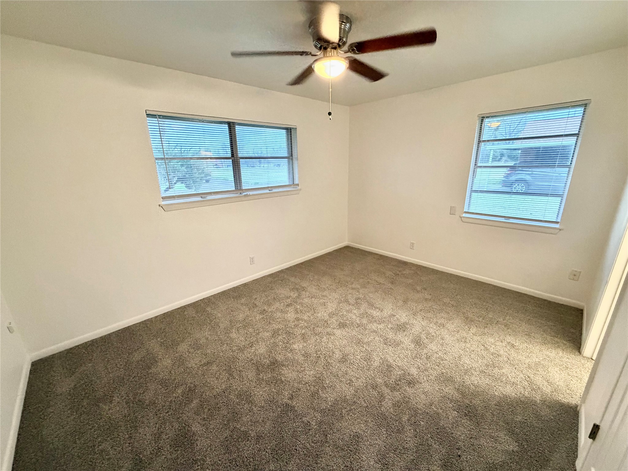 316 Angle Street Angleton, TX 77515 - Photo 21 of 30 a view of a big room with wooden floor and windows