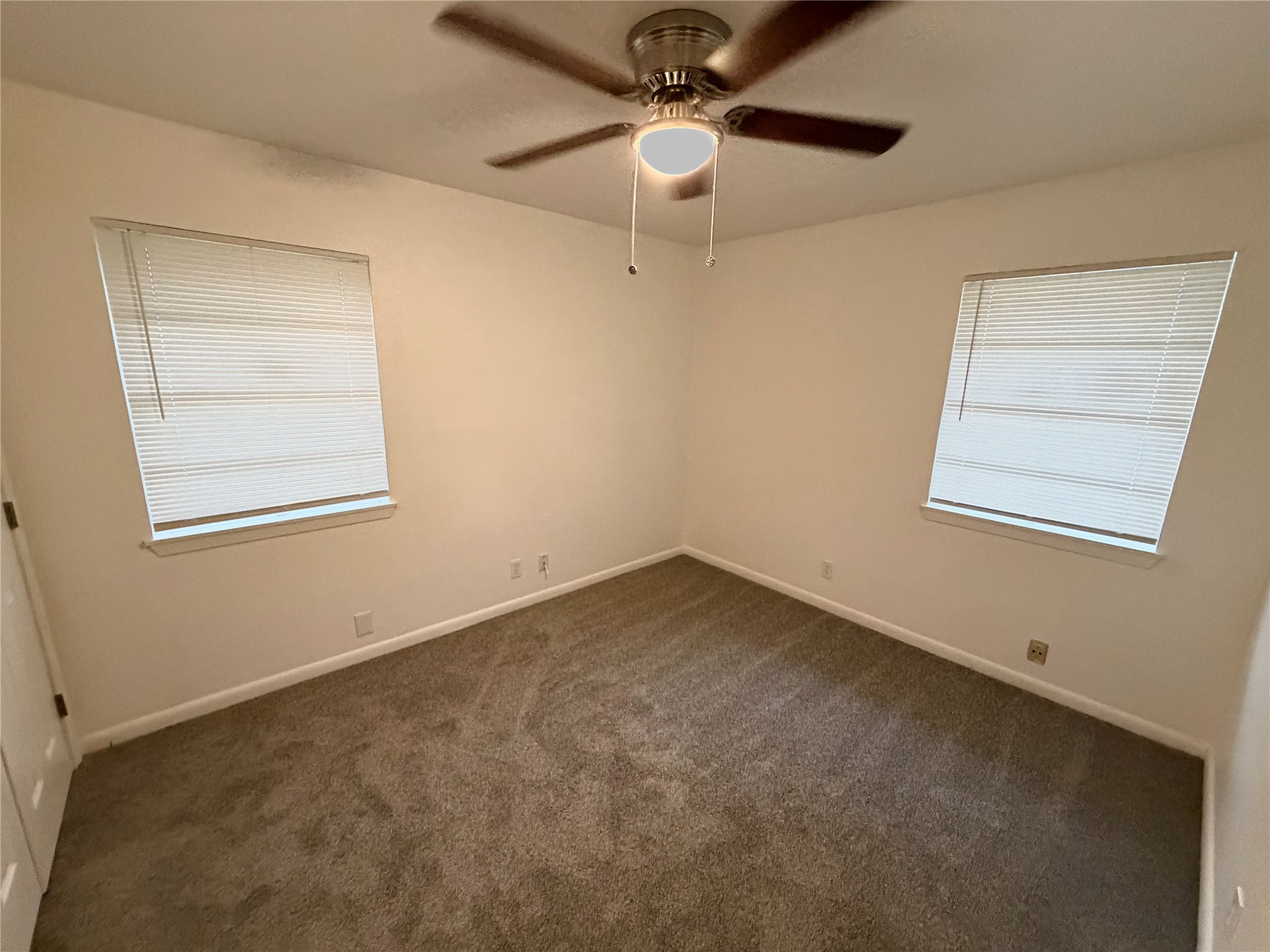 316 Angle Street Angleton, TX 77515 - Photo 24 of 30 an empty room with a window and a fan