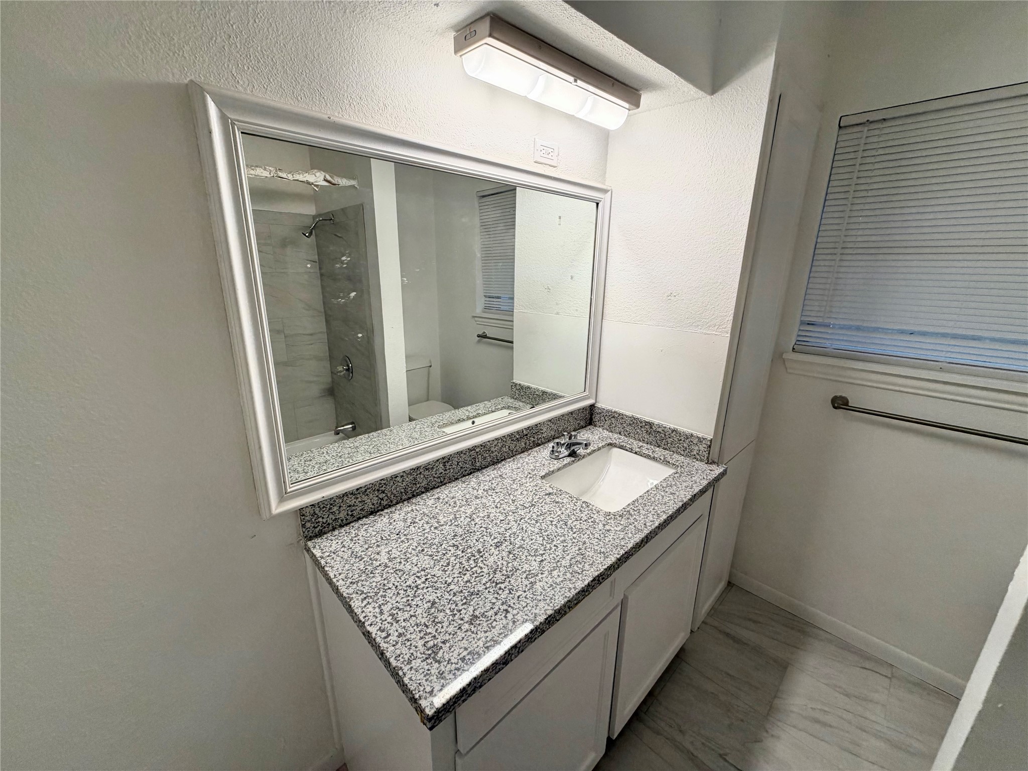 316 Angle Street Angleton, TX 77515 - Photo 26 of 30 a bathroom with a granite countertop sink and a mirror
