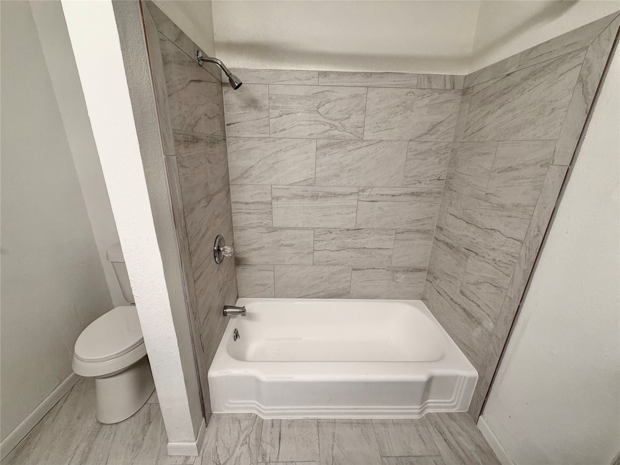 316 Angle Street Angleton, TX 77515 - Photo 27 of 30 a bathroom with a bathtub and toilet