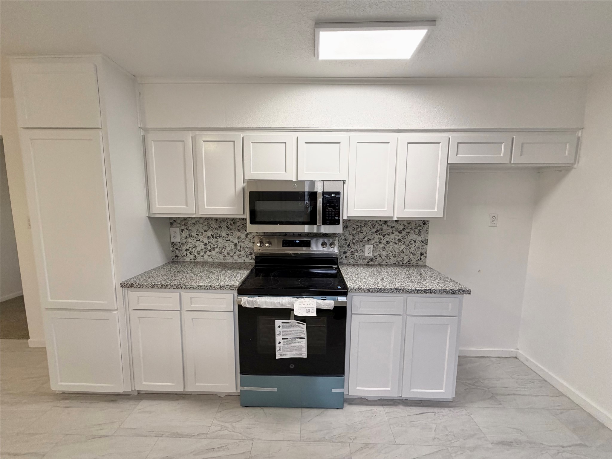 316 Angle Street Angleton, TX 77515 - Photo 8 of 30 a kitchen with white cabinets and black appliances